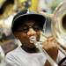 Detroit Dixon fifth-grader Kavion Bradley, 11, tests out a trombone school at Cliff Keen Arena during the 14th Annual Kids' Fair at University of Michigan on Friday. Melanie Maxwell I AnnArbor.com
